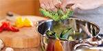 Vegetables going into pot