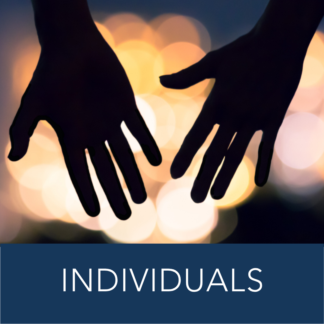 two hands reach out to clasp together in the dark