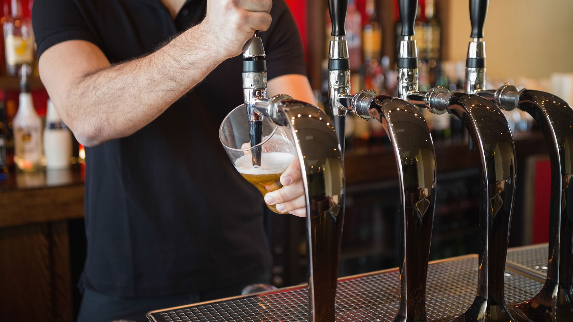 Barkeep pouring a beer