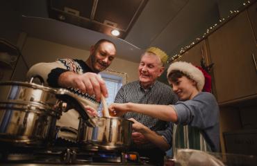 3 men cooking a meal together