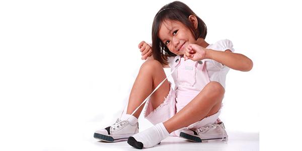 Girl Tying shoe