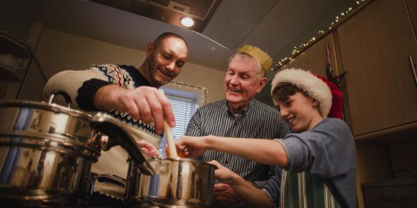 3 men cooking a meal together