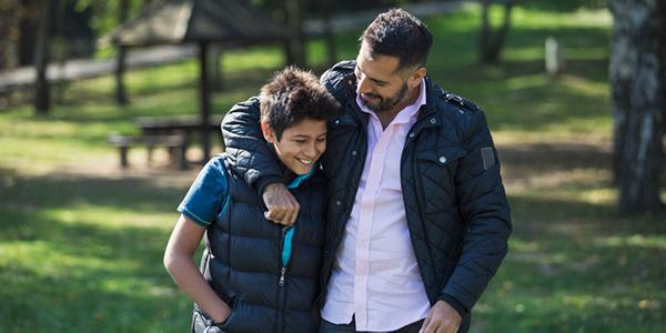 Father and Son walking in park