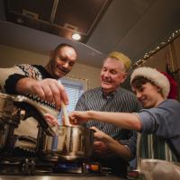 3 men cooking a meal together